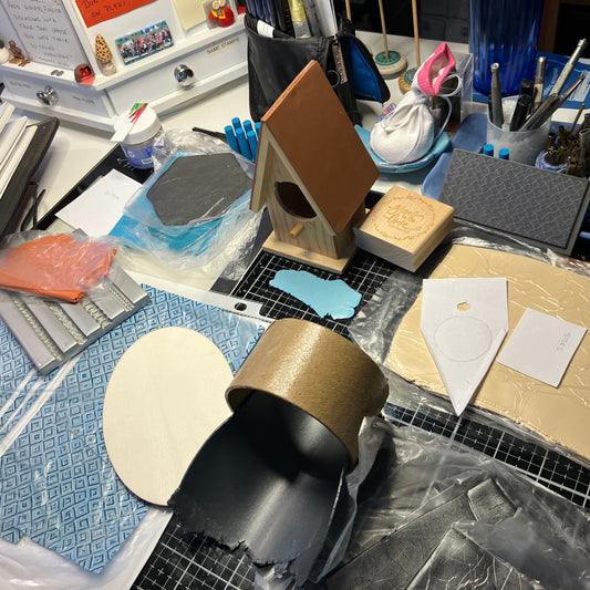 A mix of parts and patterns and colors sow the planning stages of making a new birdhouse clock.