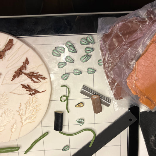 Tiny leaves and branches are made to "detail" the clock surface