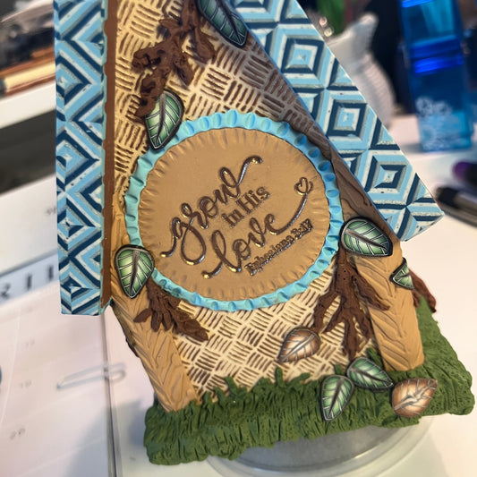 Grow in His Love is the message on the back of this new clock design from Linda Stiles Smith and NatureScapes Studio.