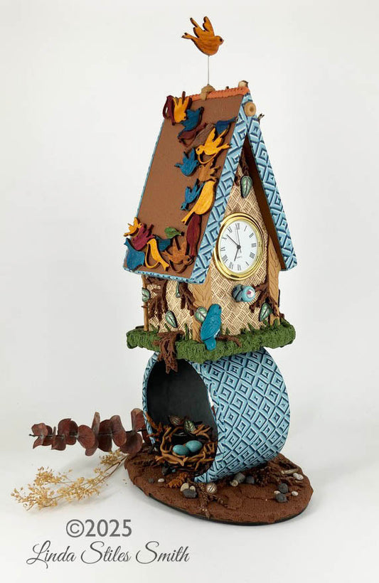 My Soul Soars! art clock sculpture of a birdhouse with a hidden nest and eggs below it.