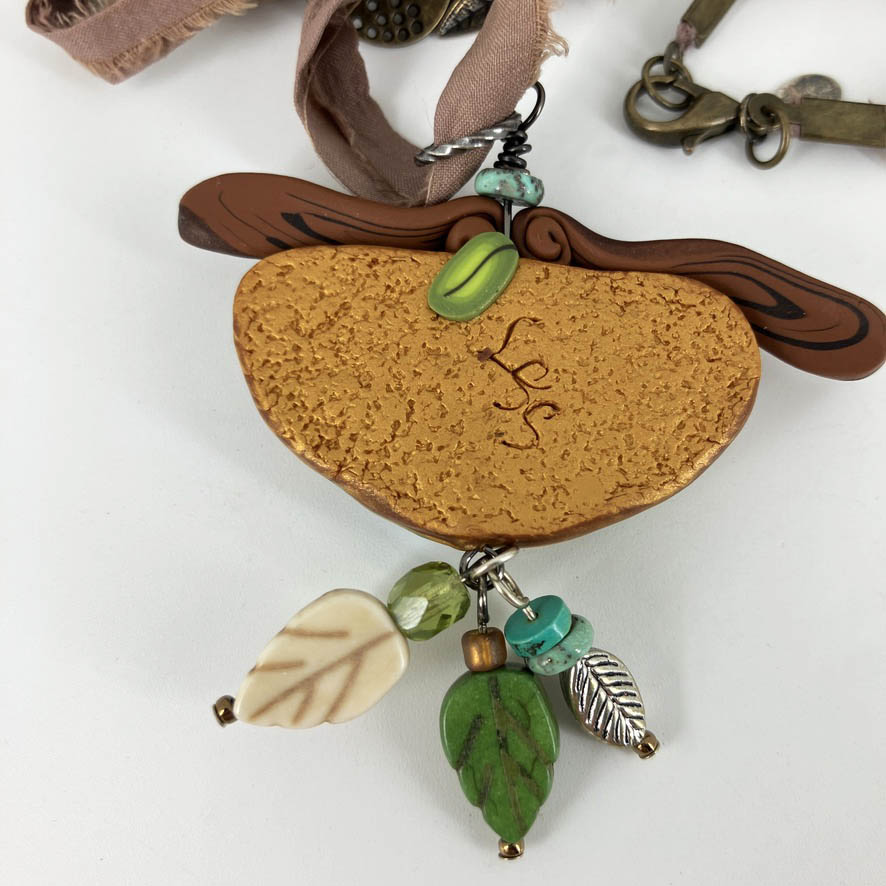 My Birdie Necklace on beaded silk cord