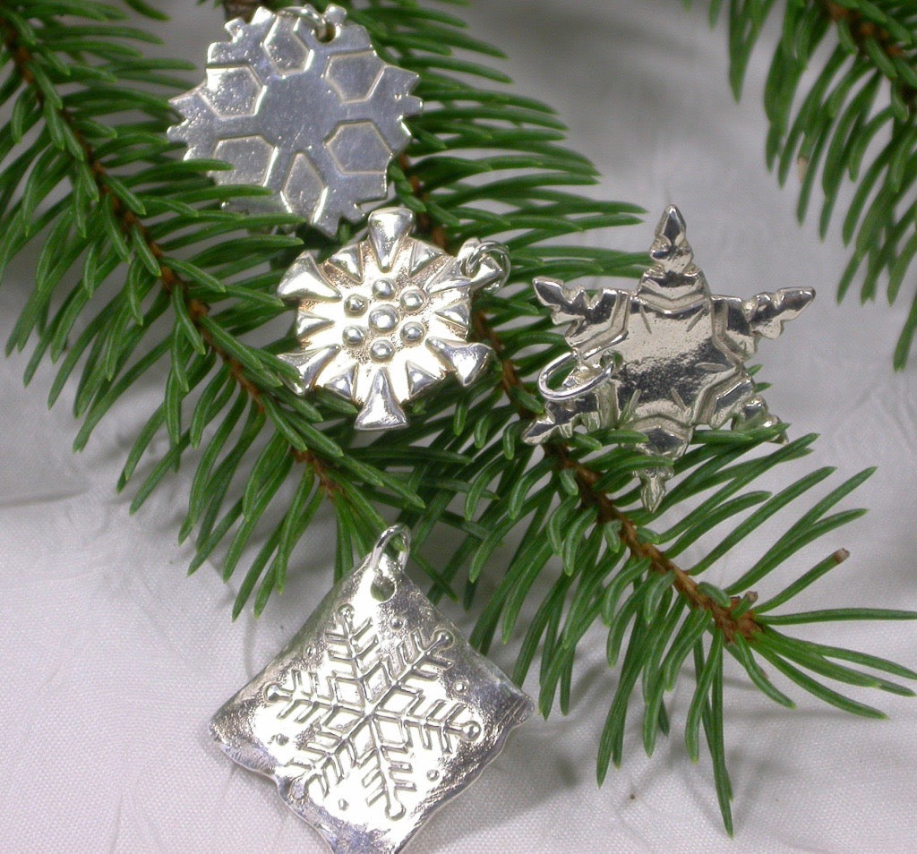 Snowflakes falling caught on a pendant with a fine silk necklace