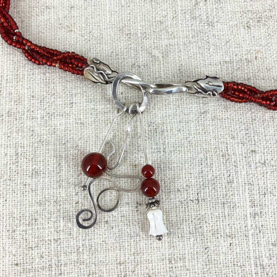 Ruby And Carnelian Wave Necklace And Earrings Set, Handmade By Linda Stiles Smith Of NatureScapes Studio. Red Round Ruby Set in a .999 Fine Silver Wave Pendant. Close-up view of the clasp. Unique gift for artistic women.