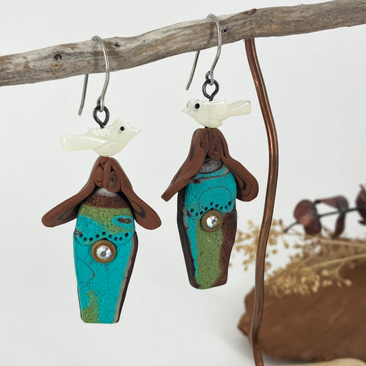 Small birdhouses in polymer clay are light weight and adorned with tiny while shell birds on sterling silver hooks.