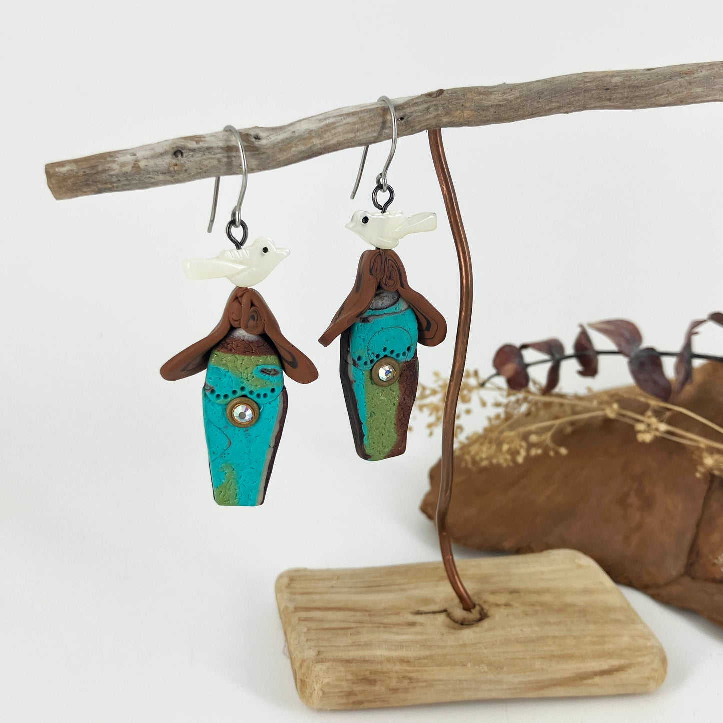 One of a kind earrings handcrafted by Linda Stiles Smith gives a nod to turquoise birdhouses for abalone shell birds sitting on top.
