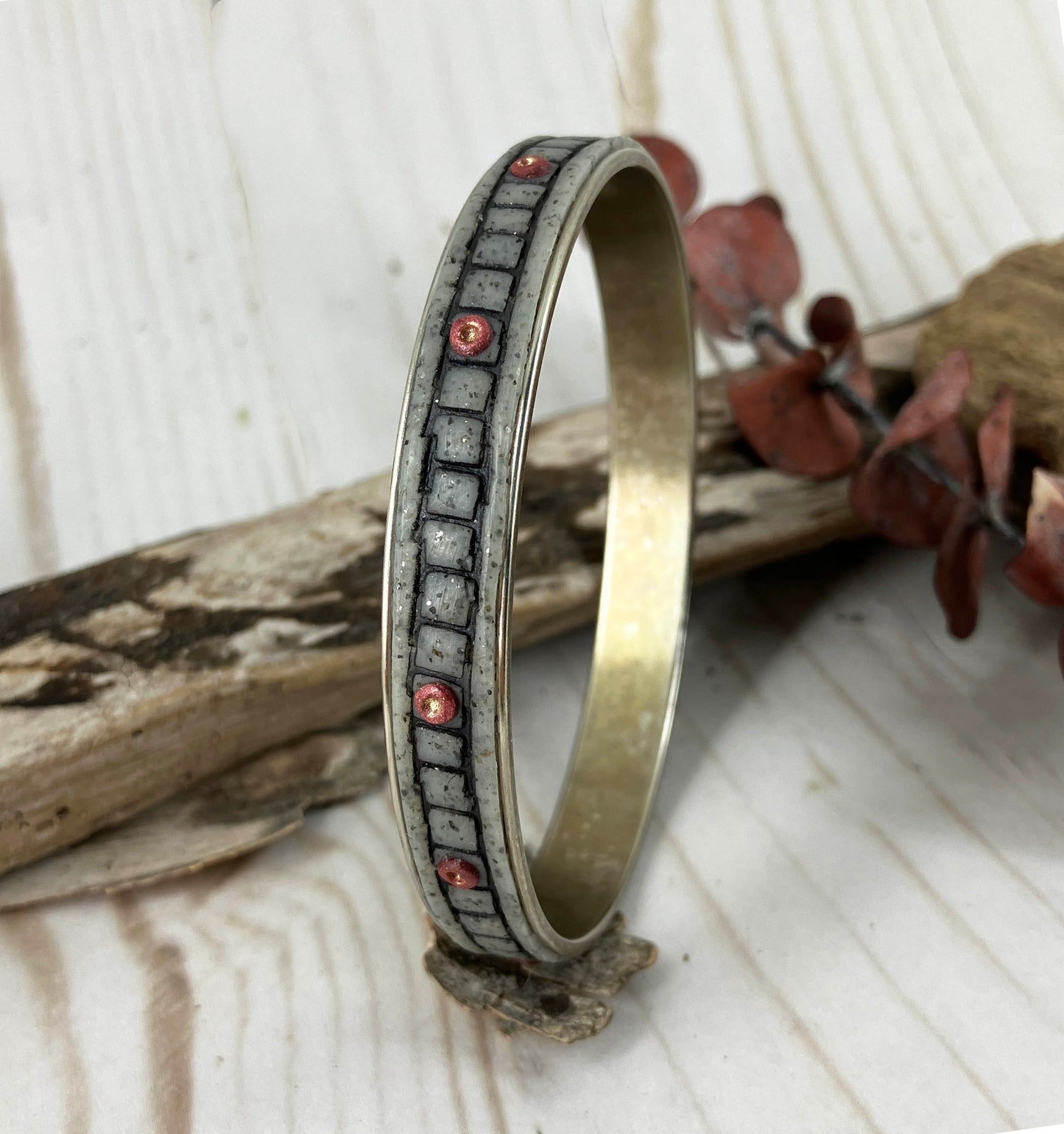 Bangle Bracelet is a block chain design in gray and black polymer clay on a silver plated metal form. Handcrafted by Linda Stiles Smith of NatureScapes Studio.