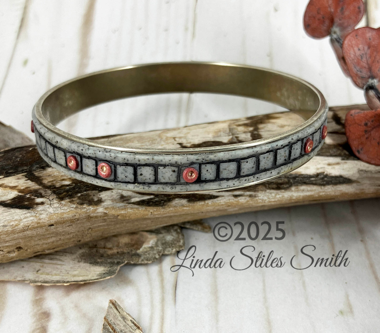 Handmade by Linda Stiles Smith this bangle bracelet design is a block chain with tiny copper dots in random blocks.
