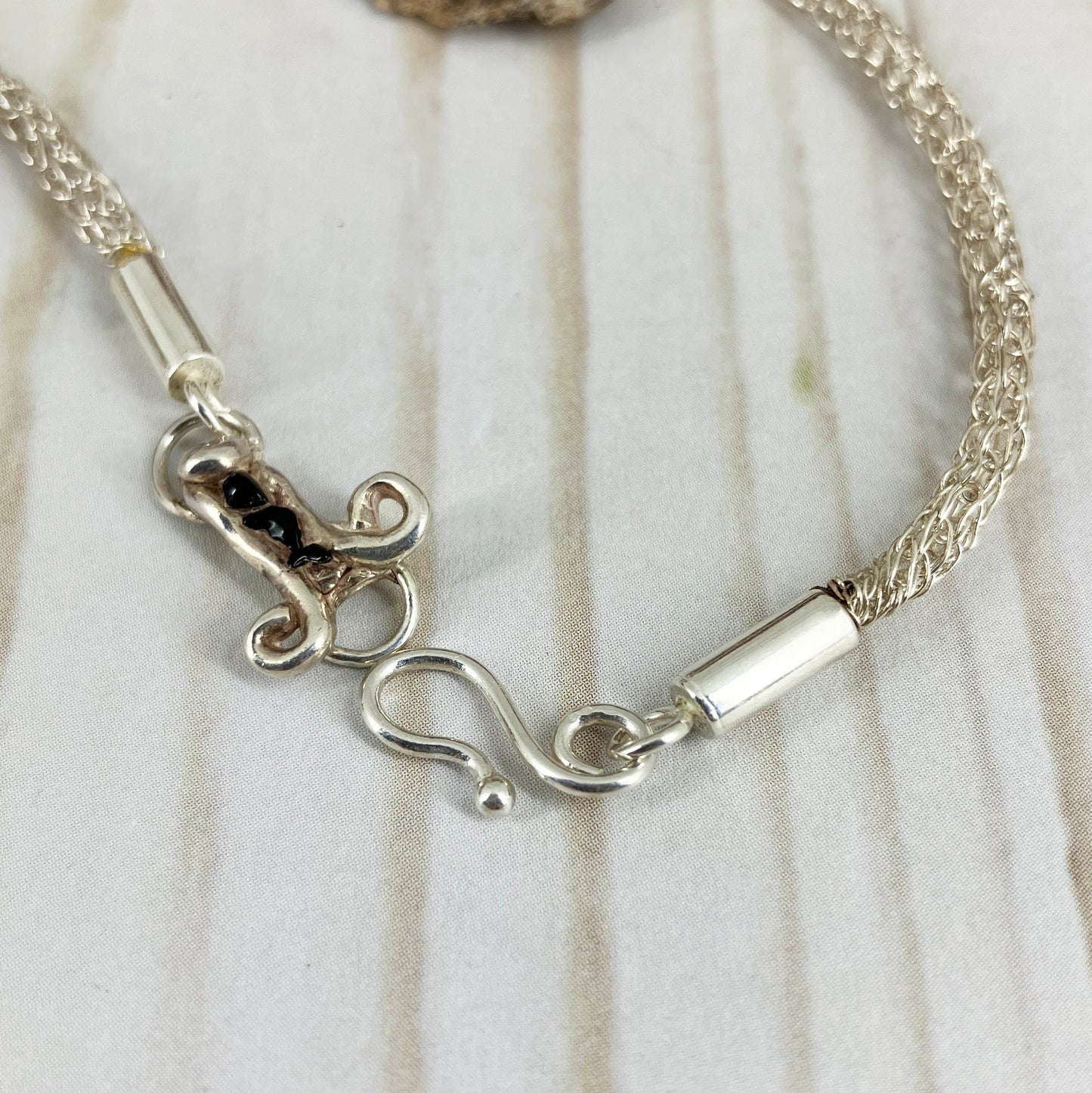 Blueberry Branch Necklace Clasp. Handcrafted by Linda Stiles Smith of NatureScapes Studio in pure fine silver. Close up of the clasp and viking knit weave chain. Collectible One Of A Kind Gift For Women.