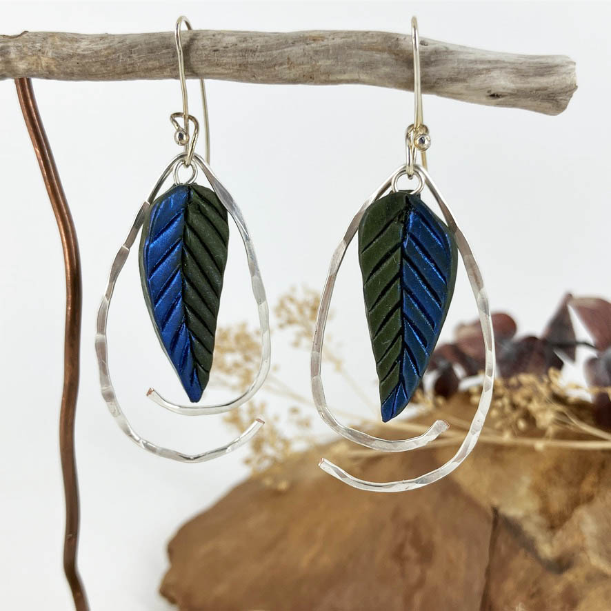 Handcrafted by jewelry artist Linda Stiles Smith of NatureScapes Studio these one of a kind blue and green leaves with a swooping wire frame are a sure style setting addition to any wardrobe.