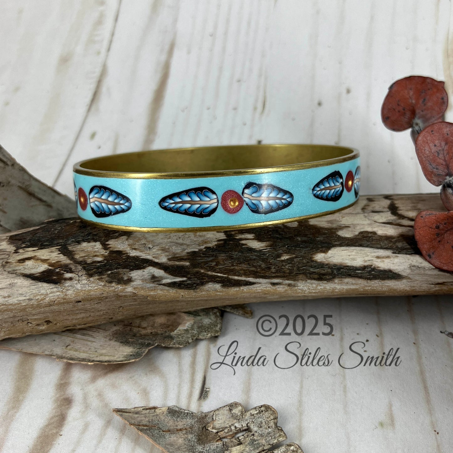Inlay leaf light blue bangle bracelet sports two leaves with a pink center point. Polished to a high shine it is one of a kind by Linda Stiles Smith