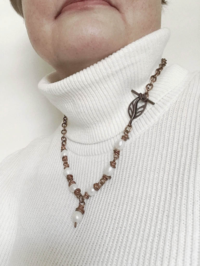 Solid Copper and Freshwater Pearl Necklace by Linda Stiles Smith of NatureScapes Studio. Made with Copper Links and 7 Freshwater White Pearls. Shown worn by a model.