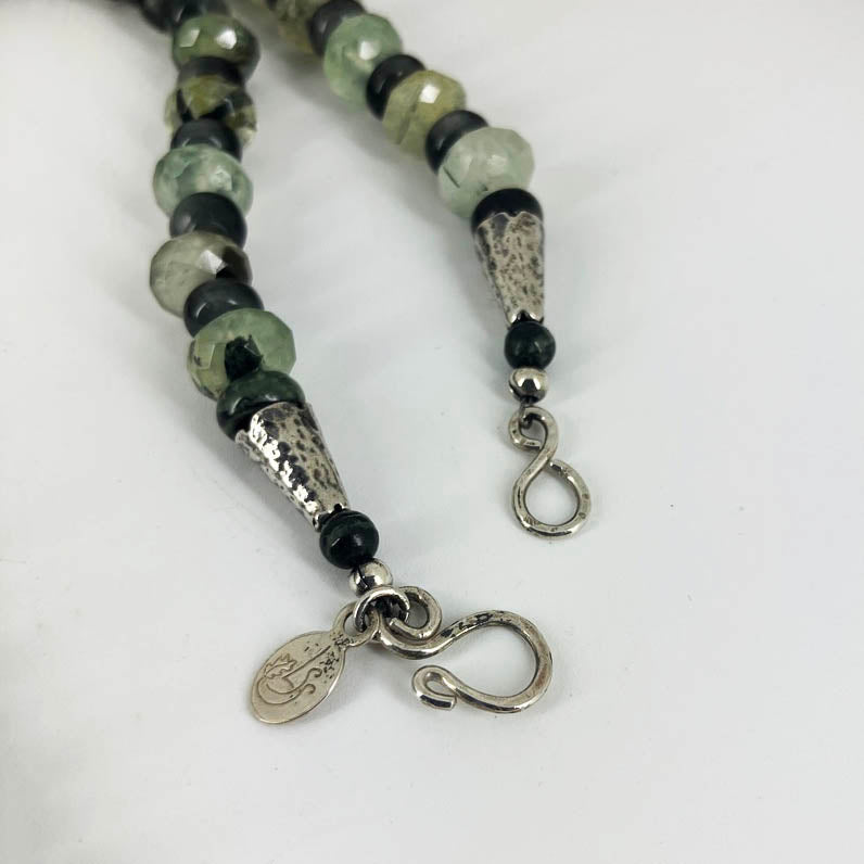 Gemstone necklace with sterling silver hook and eye clasp and makers tag.