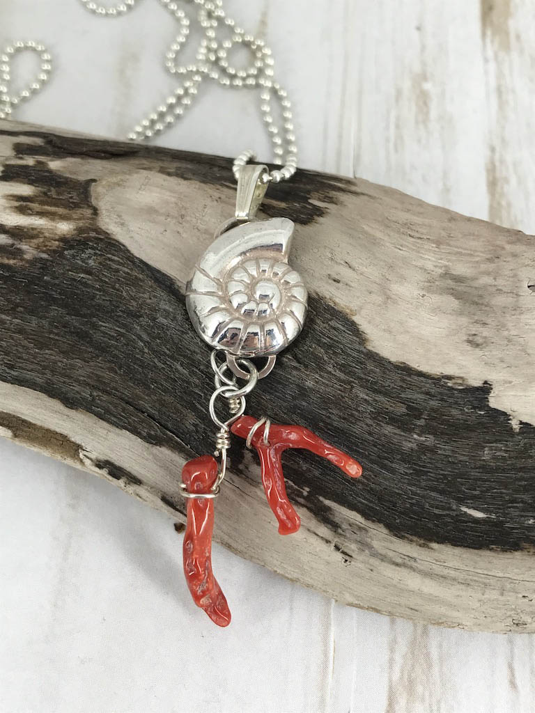 Fine silver nautilus with branch coral - a picture of the sea