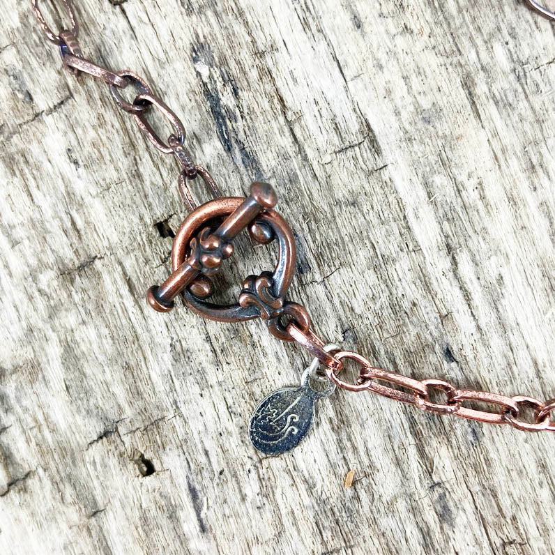 Copper toggle clasp and chain on Symbol of Love pendant designed by Linda Stiles Smith of NatureScapes Studio.