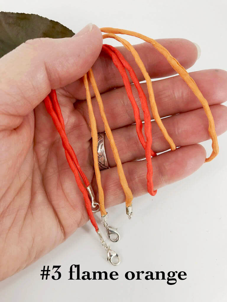 2mm thick flame orange silk cords finished with silver plated lobster or spring ring clasp, handmade accessory by Linda Stiles Smith of NatureScapes Studio.