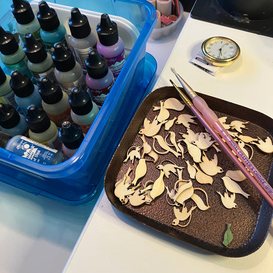 Tiny wood bird shapes are ready for me to apply colors before adding them to the clock.
