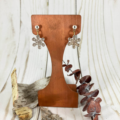 Snowflake Fine Silver Earrings By Linda Stiles Smith Of NatureScapes Studio. Front View Hanging On A Wood Display. Small Dangle Earrings Gifts For Women.