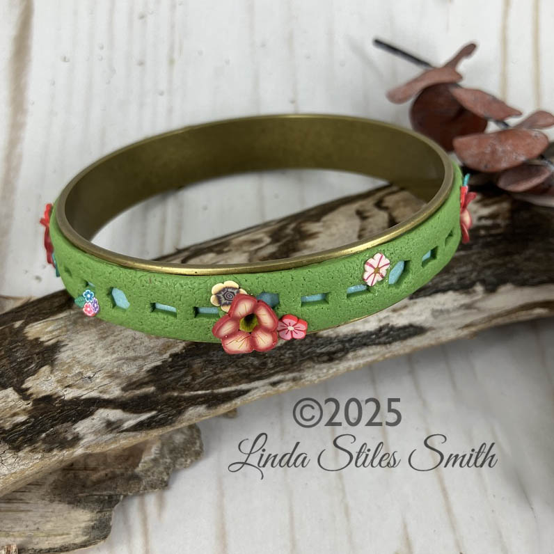 Growing flowers is easy on this leafy green bangle bracelet designed by Linda Stiles Smith. Tiny blooms pop out all along the bracelet in fun and surprising ways. From the bench of designer Linda Stiles Smith at NatureScapes Studio.