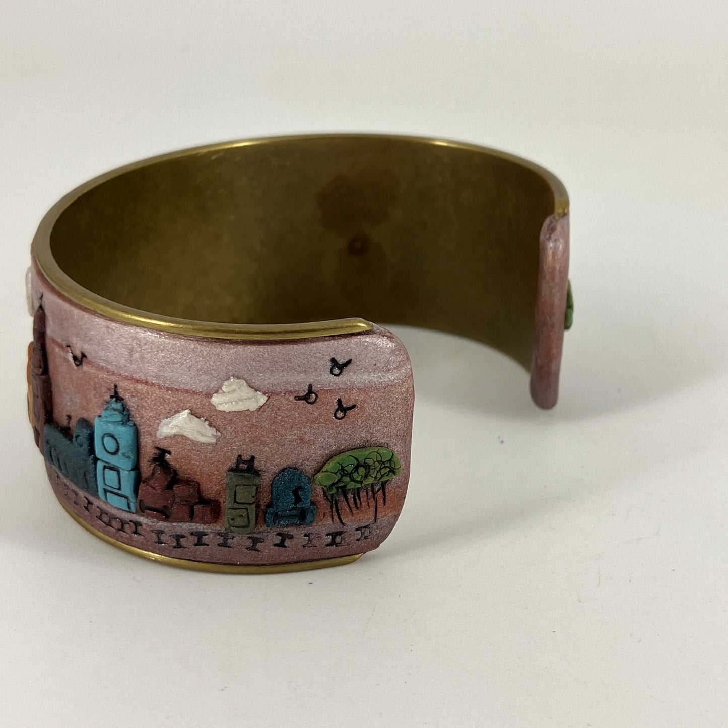 Wearable city landscapes in clay on a cuff bracelt