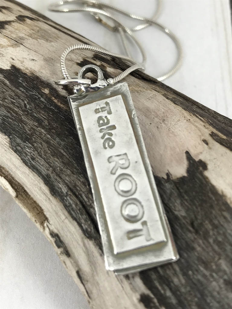 Take Root Pendant. A Unique .999 Fine Silver Message from the “Trees Speak” Series. Handmade By Linda Styles Smith Of NatureScapes Studio. Unique Gift For Women Who Love Nature. Christian Gift Idea. Back View Showing The Phrase "Take Root".