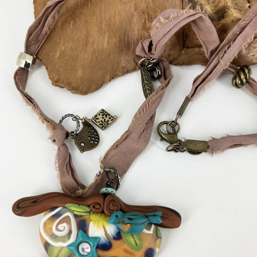 My Birdie Necklace on beaded silk cord