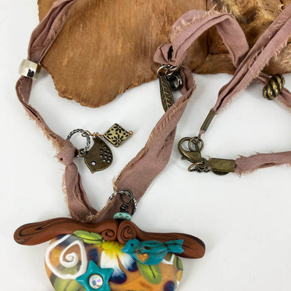 My Birdie Necklace on beaded silk cord