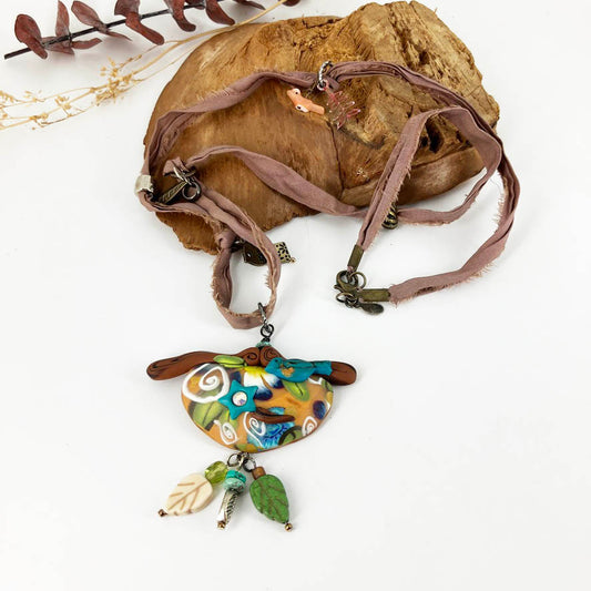 My Birdie Necklace on beaded silk cord