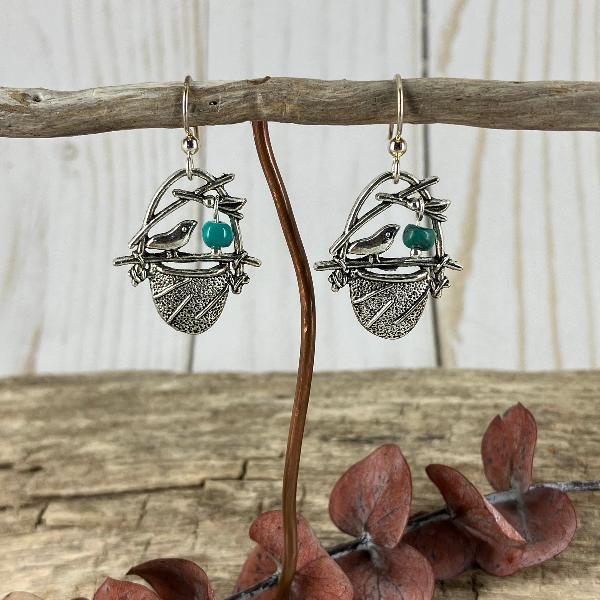 Birdsnest charms with turquoise bead egg fashioned into little nature themed earrings. Crafted by Linda Stiles Smith.