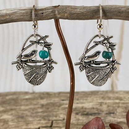 Silver birdsnest earrings with tiny turquoise gemstones as eggs from the studio of Linda Stiles Smith.