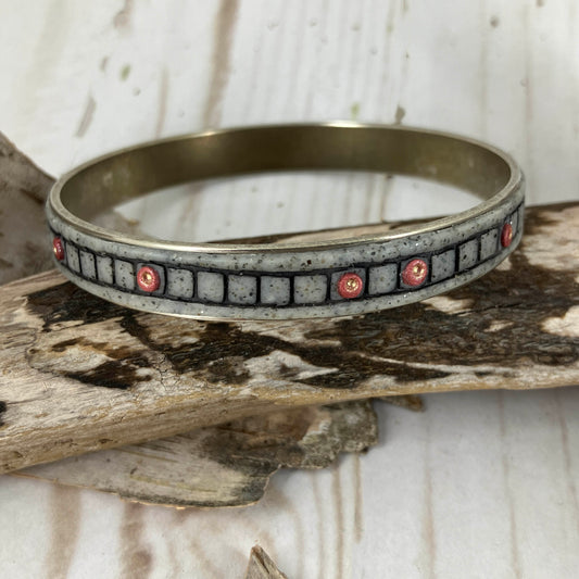 Copper dots in square blocks randomly circle the gray base clay on a silver metal bangle bracelet. Handmade by Linda Stiles Smith of NatureScapes Studio.