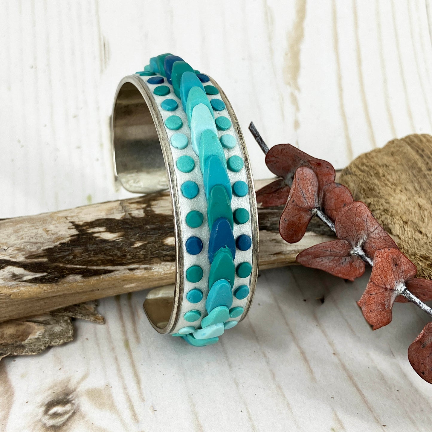 Ocean colors form waves across a silver cuff bracelet for a one of a kind piece of art jewelry. Handcrafted by Linda Stiles Smith of Naturescapes Studio. Pairs well with beachwear and casual off beach ensembles. 