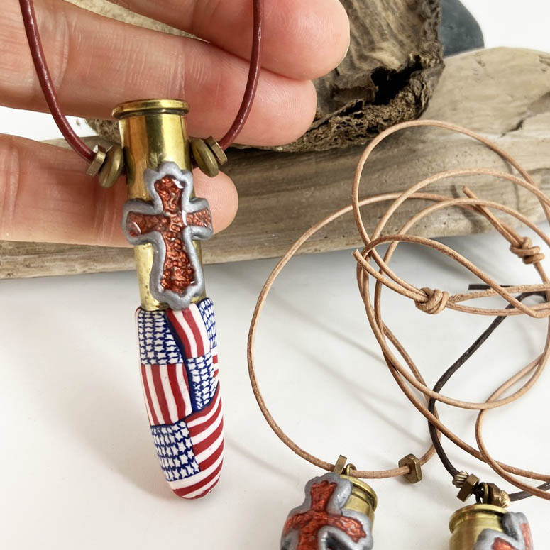 American Flag Cross Pendant Necklace - The Full Armor of God available in two sizes Small and Large. Handmade with Polymer Clay and spent brass by Linda Stiles Smith of NatureScapes Studio. Front view. Gifts for Military Patriotic Men and Women.