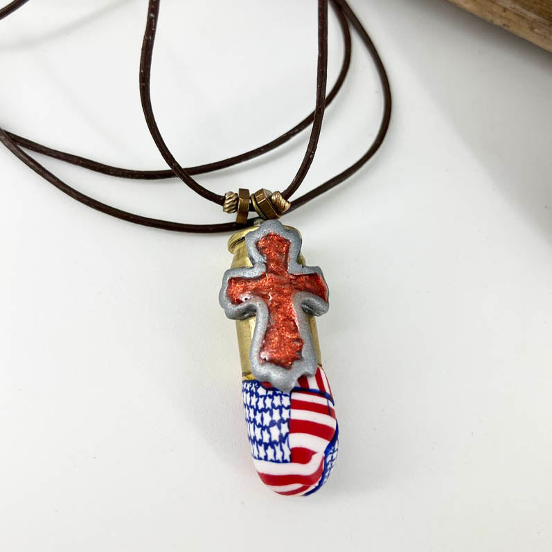 American Flag Cross Pendant Necklace - The Full Armor of God in size Small. Handmade with Polymer Clay and spent brass by Linda Stiles Smith of NatureScapes Studio. Front view. Gifts for Military Patriotic Men and Women.