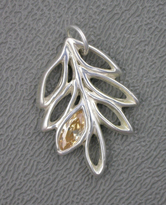 Fine silver open multi  leaf grouping pendant with champagne colored marquise shaped topaz gemstone in one leaf. Handcrafted by Linda Stiles Smith of Naturescapes Studio.