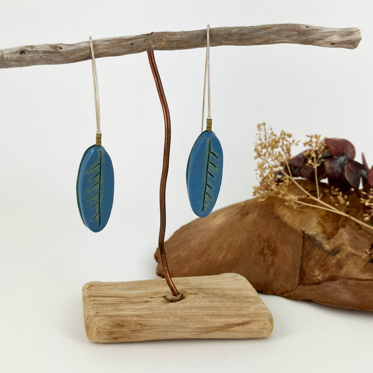 Long hook drop earrings are light weight clay leaves that sway when worn and suit any hair length. One of a kind handcrafted design by Linda Stiles Smith.