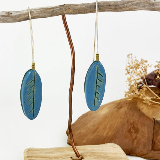 Long blue leaf shape drop from a sterling silver ear hook. Handcrafted by Linda Stiles Smith of NatureScapes Studio