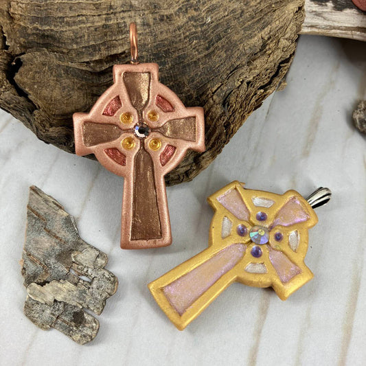 Abide in Me Medium Celtic Cross Pendant Handcrafted in Polymer Clay and genuine Swarovski Crystals by Linda Stiles Smith of NatureScapes Studio. Front View of the Bronze clay color and the Gold clay color. Christian Gifts For Women.