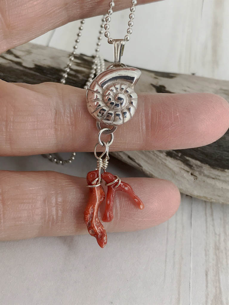 Fine silver nautilus with branch coral - a picture of the sea