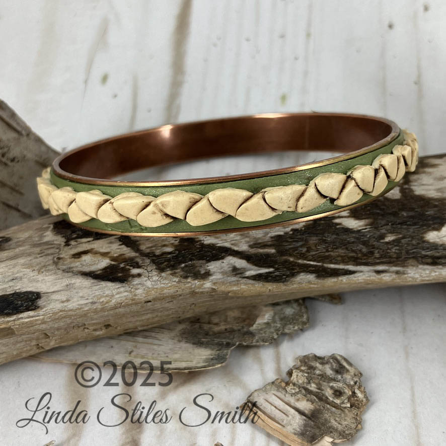 Basket weave for your wrist design in this handcrafted bangle bracelet reminds us of old time baskets. Simple but a stand out one of a kind bracelet for your collection. By Linda Stiles Smith