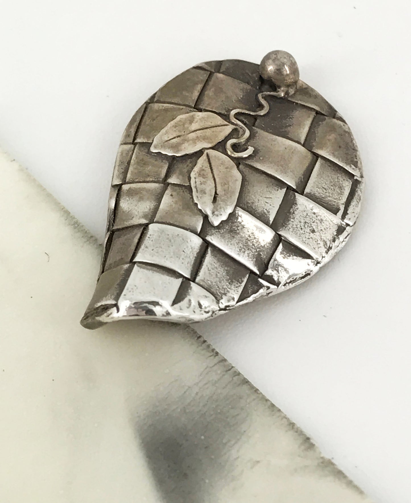 Example of the results obtained from using our 2 Inch Polishing Pads for Metal Jewelry on a Precious Metal Clay pendant by NatureScapes Studio