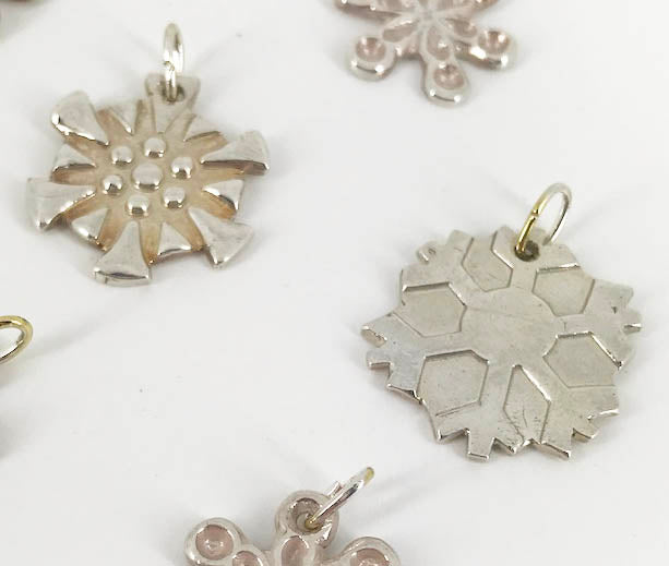 Snowflakes falling caught on a pendant with a fine silk necklace