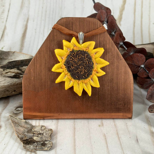 Sunflower pendant handcrafted in polymer clay with micro bead golden center accents. On sterling silver bail. Handcrafted by Linda Stiles Smith for flower lovers.