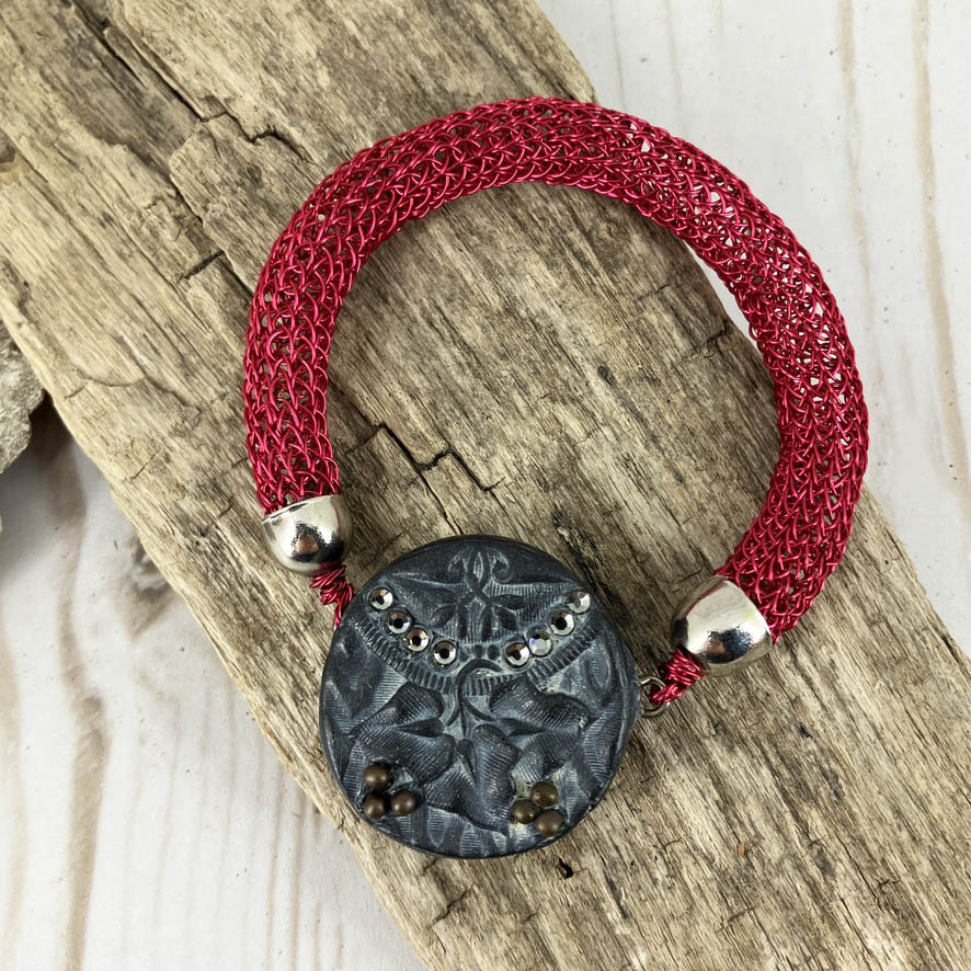 Red viking knit bracelt with magnetic polymer clay art deco clasp for women with bold fashion sense. Handcrafted by Linda Stiles Smith 