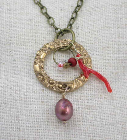 Handmade gift for women made of bronze metal clay and paired with a beautiful large pearl, coordinated beads and a branch coral piece, on a steel necklace chain. Handmade by Linda Stiles Smith of NatureScapes Studio. Front View.