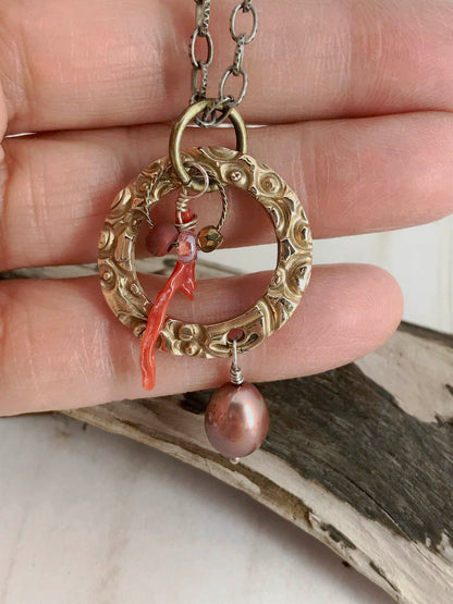 Handmade gift for women made of bronze metal clay and paired with a beautiful large pearl, coordinated beads and a branch coral piece, on a steel necklace chain. Handmade by Linda Stiles Smith of NatureScapes Studio. Front View.