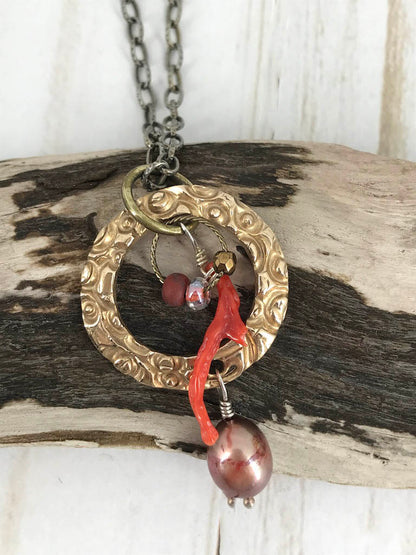 Handmade gift for women made of bronze metal clay and paired with a beautiful large pearl, coordinated beads and a branch coral piece, on a steel necklace chain. Handmade by Linda Stiles Smith of NatureScapes Studio. Front View.