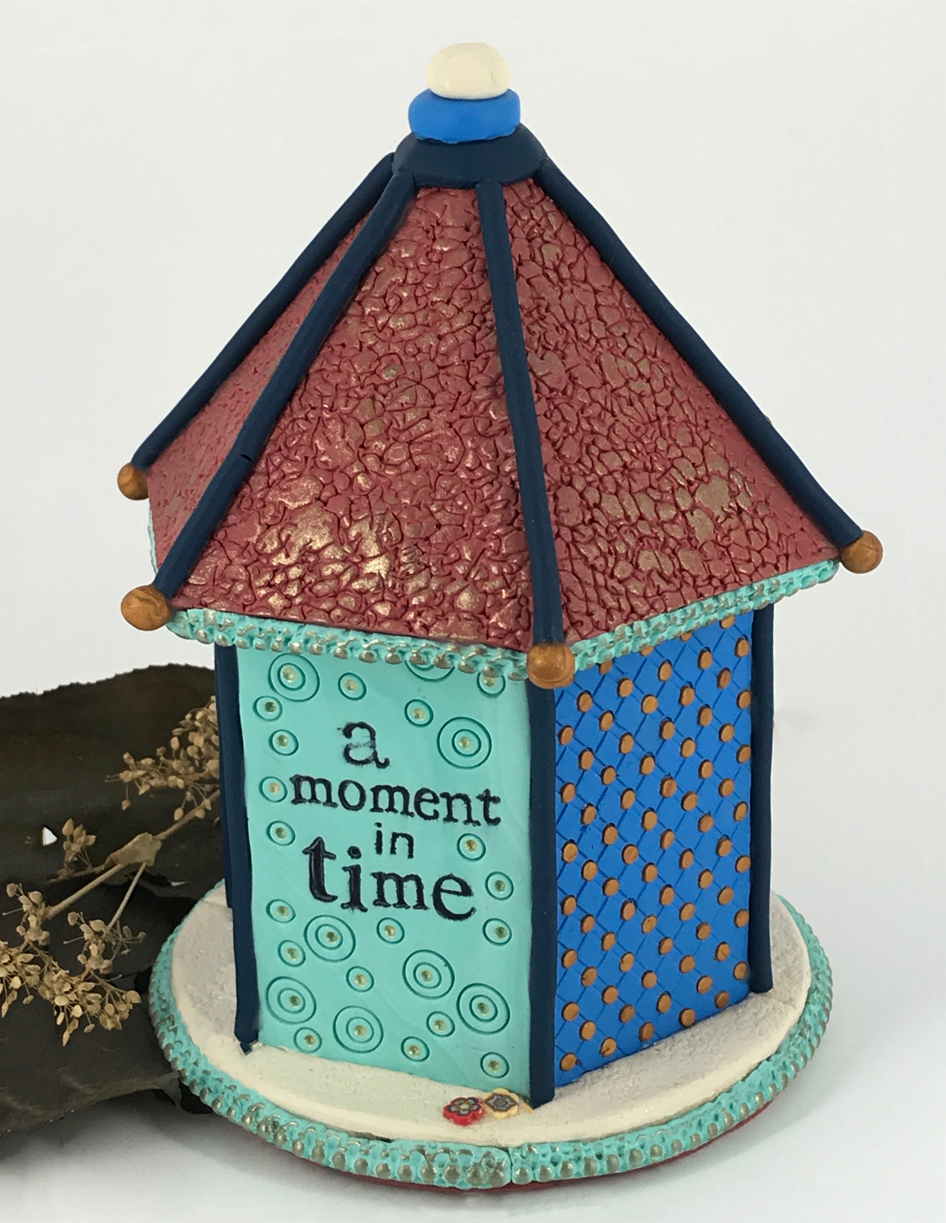 Small blue dot on shelf bird house clock handmade with Polymer Clay by Linda Stiles Smith of NatureScapes Studio. Back View stamped with the words "a moment in time". Gift for women ideas.