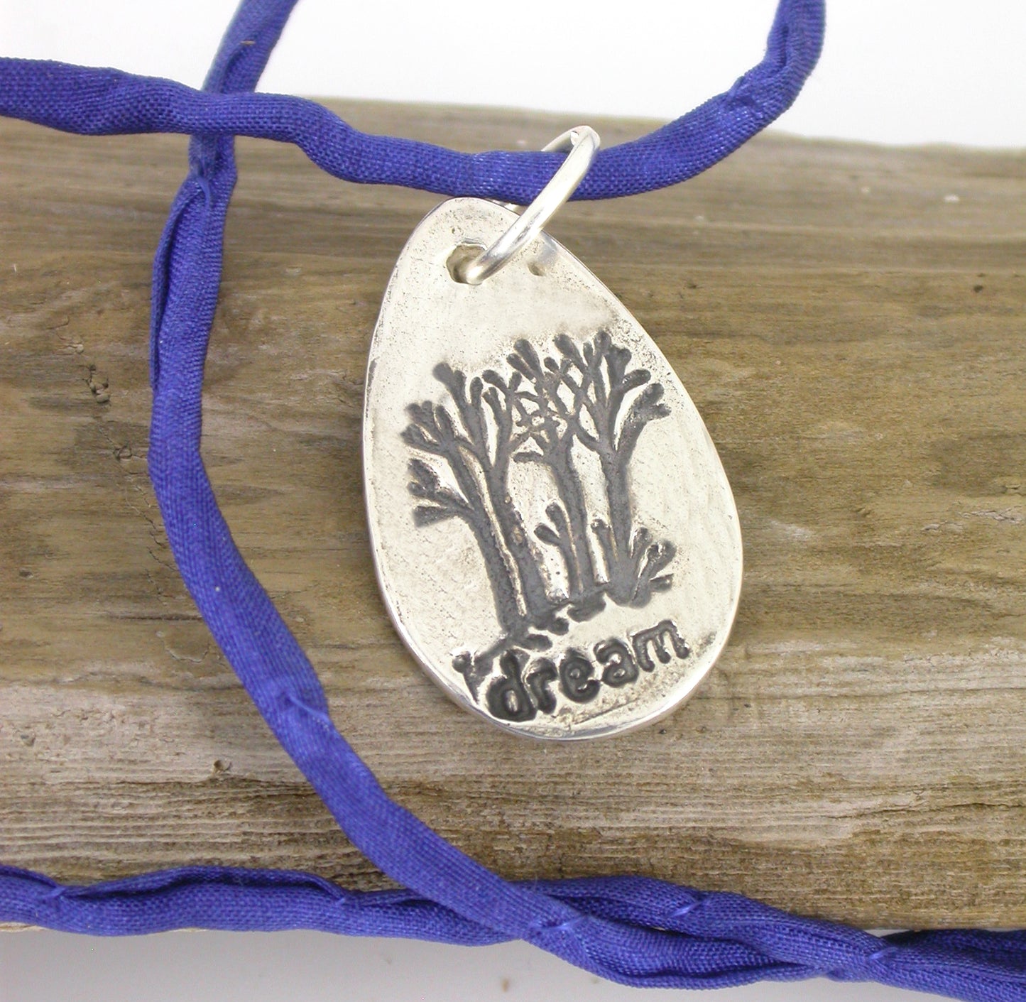 Fine silver handmade Dream On Forest pendent on a blue silk neck cord by Linda Stiles Smith of NatureScapes Studio. Front view. Gift ideas for women.