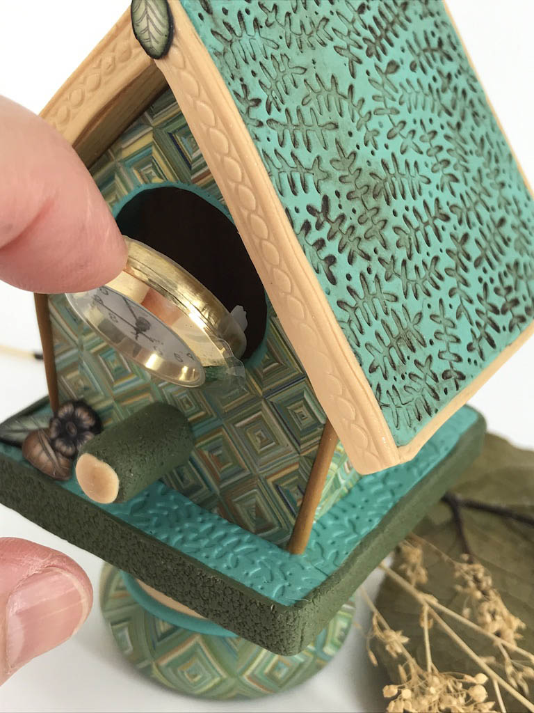 Example on how to open the clock mechanism to access the back of the mechanism on bird house clocks handmade with Polymer Clay by Linda Stiles Smith of NatureScapes Studio. Front view. Gift ideas for women.