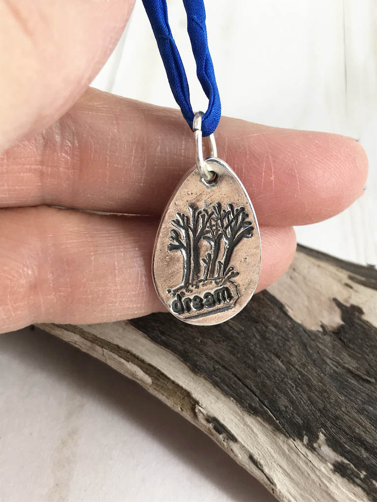 Fine silver handmade Dream On Forest pendent on a blue silk neck cord by Linda Stiles Smith of NatureScapes Studio. Front view. Gift ideas for women.